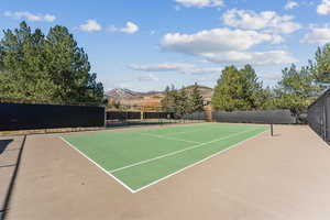 View of tennis court featuring a mountain view and community basketball court