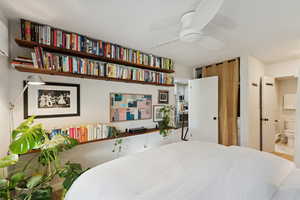 Bedroom featuring ensuite bath and ceiling fan