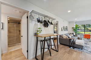 Dining space with recessed lighting and light wood-style flooring