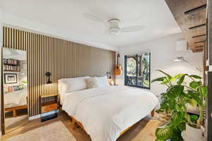 Bedroom featuring wood finished floors and a ceiling fan