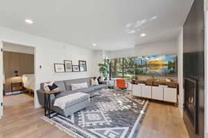 Living area featuring light wood-style flooring and recessed lighting