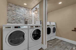 Community laundry featuring washer and dryer and recessed lighting