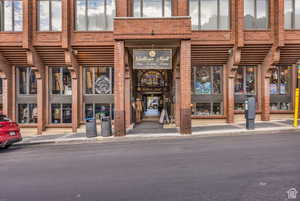 View of exterior entry with brick siding
