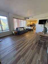 Living room with dark wood-style floors and a textured ceiling