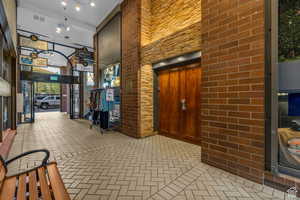 Building lobby with a towering ceiling and brick wall
