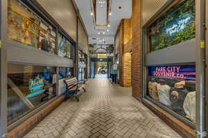 Building lobby featuring a towering ceiling and brick wall