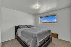 Carpeted bedroom with baseboards