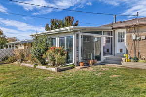Rear view of house with a sunroom and brick siding