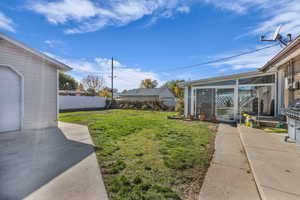 View of yard featuring a sunroom