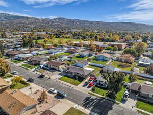Aerial perspective of suburban area featuring a mountain backdrop