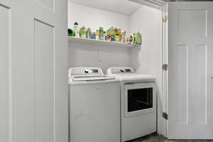 Laundry room featuring washer and clothes dryer
