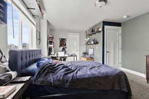 Carpeted bedroom with baseboards