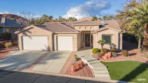 Mediterranean / spanish house featuring stucco siding, an attached garage, driveway, and a tiled roof