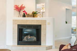 Detailed view of a fireplace and a ceiling fan