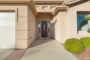 Property entrance featuring stucco siding