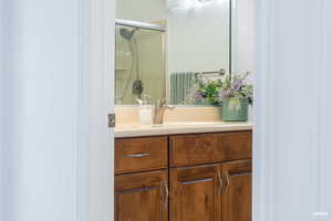 Full bathroom with vanity and a stall shower