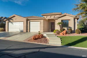 Mediterranean / spanish home featuring a tile roof, a garage, stucco siding, concrete driveway, and a front lawn