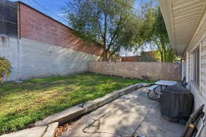 Fenced backyard featuring a patio