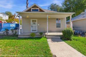 View of front of home with covered porch and roof with shingles