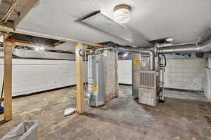 Unfinished basement with gas water heater and heating unit