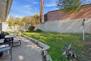 View of yard featuring a patio and a storage unit