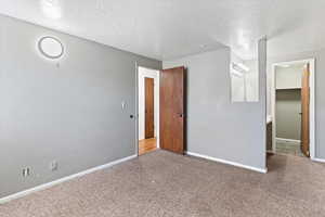 Spare room with carpet flooring and a textured ceiling