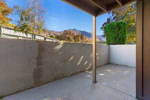 Fenced backyard featuring a patio area and a mountain view