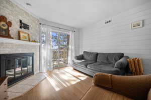 Living area with a fireplace and wood finished floors