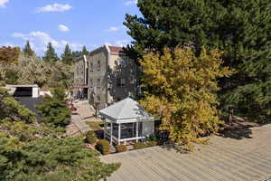 Aerial view of property and surrounding area with a tree filled landscape