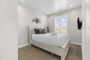 Bedroom with light carpet and recessed lighting