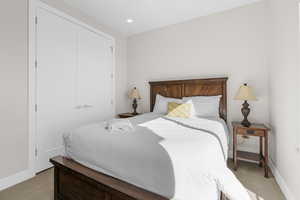 Carpeted bedroom featuring a closet and recessed lighting