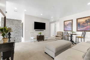 Carpeted living room featuring recessed lighting and baseboards