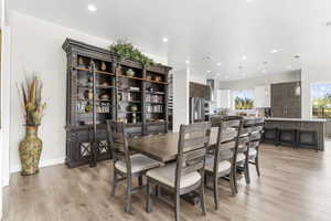 Dining room featuring light wood-style floors and recessed lighting