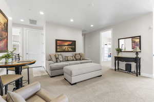Living room featuring light carpet and recessed lighting
