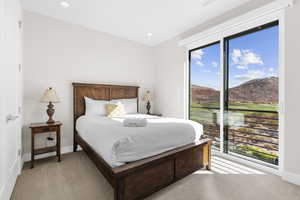 Bedroom with light colored carpet, access to exterior, a mountain view, and recessed lighting