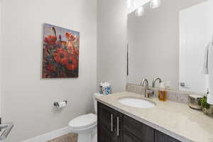 Half bathroom with vanity and light tile patterned floors