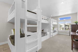 Bedroom with light carpet, recessed lighting, and a textured ceiling