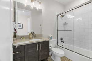 Full bath with vanity and shower / bath combination with glass door
