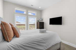 Carpeted bedroom featuring baseboards and recessed lighting
