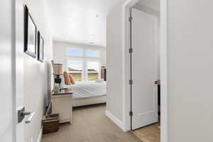 Hall with light carpet and recessed lighting