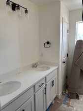 Full bath featuring double vanity