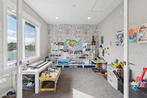 Rec room with carpet flooring, recessed lighting, and an accent wall