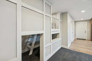 Corridor featuring light carpet and recessed lighting