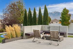 Fenced backyard featuring an outdoor fire pit, a mountain view, and a patio