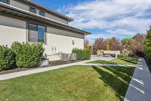 View of home's exterior featuring stucco siding and a patio
