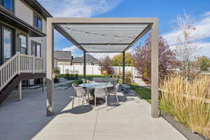 Fenced backyard with a patio, outdoor dining space, and a pergola