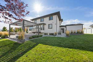 Rear view of house with a patio and stucco siding