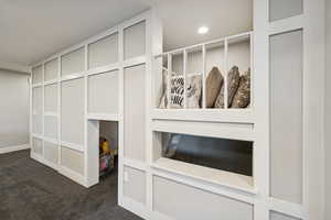 Detailed view of carpet flooring and recessed lighting