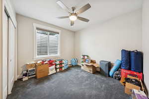 Playroom featuring dark carpet and ceiling fan