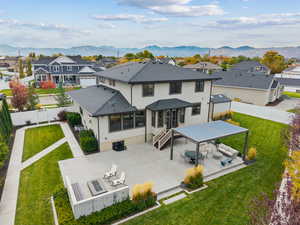 Back of property with a residential view, a fenced backyard, a patio area, and stucco siding